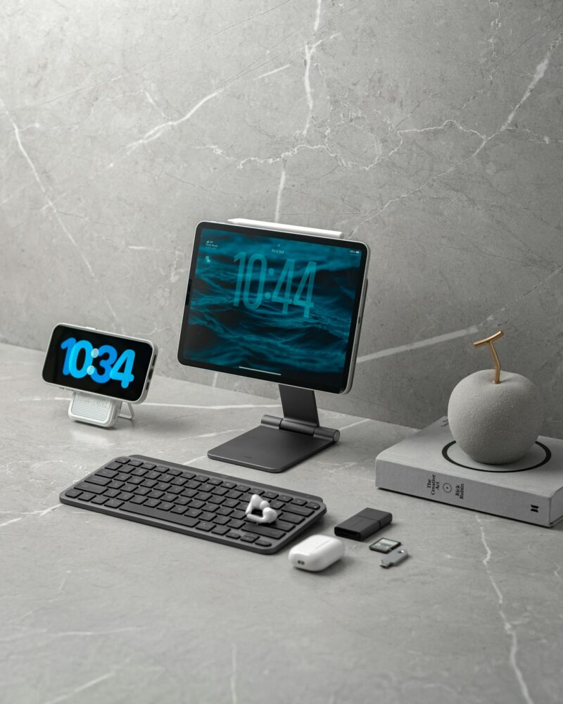 Digital devices and office accessories arranged on a marble surface.